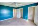 Bedroom with blue walls, natural light, and closet access at 2068 Hampton Locust Grove Rd, Locust Grove, GA 30248