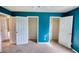Bedroom featuring blue walls and two closets at 2068 Hampton Locust Grove Rd, Locust Grove, GA 30248