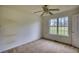 Bedroom features carpet, natural light from window, and ceiling fan at 2068 Hampton Locust Grove Rd, Locust Grove, GA 30248