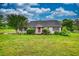 Inviting ranch-style home with a red front door, framed by lush landscaping on a spacious, green lawn at 2068 Hampton Locust Grove Rd, Locust Grove, GA 30248