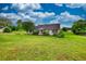 A well-kept ranch home, set back on a sprawling green lawn with mature trees and charming curb appeal at 2068 Hampton Locust Grove Rd, Locust Grove, GA 30248