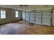 Spacious garage features windows, concrete floor, and a large garage door at 2068 Hampton Locust Grove Rd, Locust Grove, GA 30248