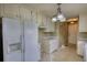 Galley kitchen with white cabinets, and bright lighting at 2068 Hampton Locust Grove Rd, Locust Grove, GA 30248