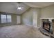 Open living area featuring a vaulted ceiling and corner stone fireplace, ready for your personal design at 2068 Hampton Locust Grove Rd, Locust Grove, GA 30248