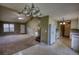Spacious living room featuring a vaulted ceiling, fireplace, and views into the connected kitchen at 2068 Hampton Locust Grove Rd, Locust Grove, GA 30248