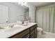 Neutral bathroom features double sink vanity, large mirror, and shower with curtain at 340 Paulownia Cir, Mcdonough, GA 30253