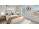 This bright bedroom features carpet, neutral walls, two windows and simple modern decor at 340 Paulownia Cir, Mcdonough, GA 30253
