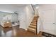 Open foyer featuring hardwood floors, staircase, and access to the living room; with natural light at 340 Paulownia Cir, Mcdonough, GA 30253