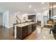 Spacious kitchen featuring a large island, granite countertops, stainless steel appliances, and wood cabinets at 340 Paulownia Cir, Mcdonough, GA 30253