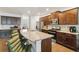 The kitchen features stainless steel appliances, granite countertops, dark cabinets, and a breakfast bar with stylish green seating at 340 Paulownia Cir, Mcdonough, GA 30253