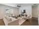 The living room is well-lit, and features hardwood floors, a fireplace, a ceiling fan, and neutral furniture at 340 Paulownia Cir, Mcdonough, GA 30253