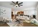 The open-concept living room offers hardwood floors, neutral walls, plenty of seating, and views into the kitchen at 340 Paulownia Cir, Mcdonough, GA 30253