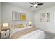 A beautifully staged main bedroom features neutral walls, carpet, a ceiling fan, and modern decor at 340 Paulownia Cir, Mcdonough, GA 30253
