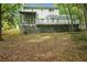 Two-story house with deck and screened porch, surrounded by lush bamboo, offering outdoor living in a serene backyard at 3688 Burnley Court, Lithonia, GA 30038