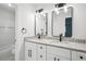 Modern bathroom with double sinks, granite counters, white cabinets, and black hardware at 3688 Burnley Court, Lithonia, GA 30038