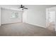 Spacious bedroom with a ceiling fan, neutral carpet, white walls, and a window at 3688 Burnley Court, Lithonia, GA 30038