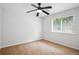 Carpeted bedroom featuring a ceiling fan and a window with blinds at 3688 Burnley Court, Lithonia, GA 30038