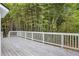 Spacious deck with white railings overlooking a lush landscape of bamboo trees, enhancing privacy and serenity at 3688 Burnley Court, Lithonia, GA 30038