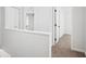 Upstairs hallway with carpet floors, white walls, and several doors leading to bedrooms at 3688 Burnley Court, Lithonia, GA 30038