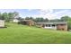Expansive green backyard featuring a screened-in porch and additional outbuildings at 4642 Elmhurst Dr, Douglasville, GA 30135
