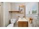Cozy bathroom featuring tile floors and walls, wood vanity and lots of natural light at 4642 Elmhurst Dr, Douglasville, GA 30135