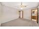Neutral bedroom showcasing carpet, ceiling fan and easy access to the bathroom at 4642 Elmhurst Dr, Douglasville, GA 30135