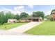 Exterior view of home with long driveway and big front yard at 4642 Elmhurst Dr, Douglasville, GA 30135