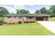 Charming brick home with a well-maintained lawn, covered porch and carport at 4642 Elmhurst Dr, Douglasville, GA 30135