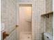 Bathroom shower featuring tile surround, shower curtain and safety grab bars at 4642 Elmhurst Dr, Douglasville, GA 30135