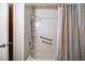 Bathroom tub/shower combo featuring a shower curtain and safety grab bars at 4642 Elmhurst Dr, Douglasville, GA 30135