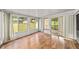 Bright sunroom featuring wood floors, and large windows overlooking the lawn at 4642 Elmhurst Dr, Douglasville, GA 30135