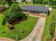 Aerial view of a landscaped front yard with mature trees and a long driveway at 620 Clearbrook Ct, Marietta, GA 30068