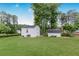 Expansive backyard featuring a storage sheds, luscious green lawn and mature trees at 620 Clearbrook Ct, Marietta, GA 30068