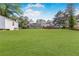 Expansive backyard featuring a well-manicured lawn, a charming deck, and lush, mature trees for added privacy at 620 Clearbrook Ct, Marietta, GA 30068
