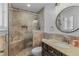 The bathroom features a gorgeous tiled walk-in shower with a bench and updated vanity at 620 Clearbrook Ct, Marietta, GA 30068