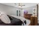Bedroom featuring hardwood floors, ceiling fan, ensuite bath with shower, and view of a backyard deck at 620 Clearbrook Ct, Marietta, GA 30068