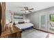 A bedroom with gray walls, ceiling fan, hardwood floors, and access to the outdoor deck through French doors at 620 Clearbrook Ct, Marietta, GA 30068