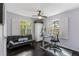 Bedroom with hardwood floors, office setup, futon, and large windows at 620 Clearbrook Ct, Marietta, GA 30068