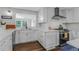 Bright kitchen featuring white cabinetry, stainless steel appliances, and wood-look flooring at 620 Clearbrook Ct, Marietta, GA 30068