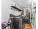 Functional laundry room with modern washer and dryer, shelving, and overhead lighting at 620 Clearbrook Ct, Marietta, GA 30068