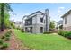 A multi-level backyard featuring a screened-in porch, stone chimney, and lush landscaping at 2578 Middle Coray Cir, Marietta, GA 30066