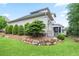 Spacious backyard featuring mature trees, lush lawn, and a charming stone retaining wall at 2578 Middle Coray Cir, Marietta, GA 30066