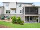 A backyard featuring a screened porch, stairs to a patio, and manicured greenery at 2578 Middle Coray Cir, Marietta, GA 30066