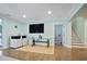Bright basement featuring stairs, door to bedroom, glass desk, a printer, and a tv at 2578 Middle Coray Cir, Marietta, GA 30066