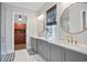 Elegant bathroom with double vanity, stylish mirrors, and a view into the closet at 2578 Middle Coray Cir, Marietta, GA 30066