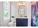 Stylish half bathroom with hexagon tiles, navy vanity, and modern fixtures at 2578 Middle Coray Cir, Marietta, GA 30066