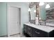 Modern bathroom featuring a double vanity with sleek black cabinets and a large mirror with decorative gold trim at 2578 Middle Coray Cir, Marietta, GA 30066