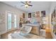 Bedroom with light wood floors, light walls, and updated ceiling fan at 2578 Middle Coray Cir, Marietta, GA 30066