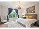 Comfortable bedroom featuring a plush rug, large windows, and elegant lighting at 2578 Middle Coray Cir, Marietta, GA 30066
