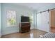 This bedroom features hardwood floors, a barn door, and windows with white shutters for natural light and privacy at 2578 Middle Coray Cir, Marietta, GA 30066